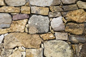 Detail of the old rustic stone wall backdrop